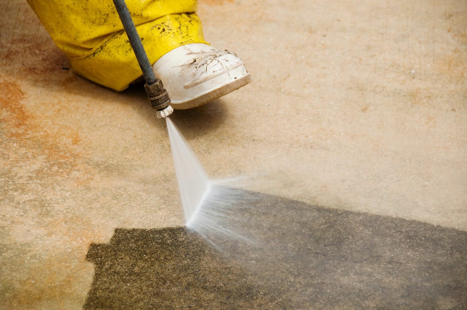 A person using a spray bottle to clean the floor.